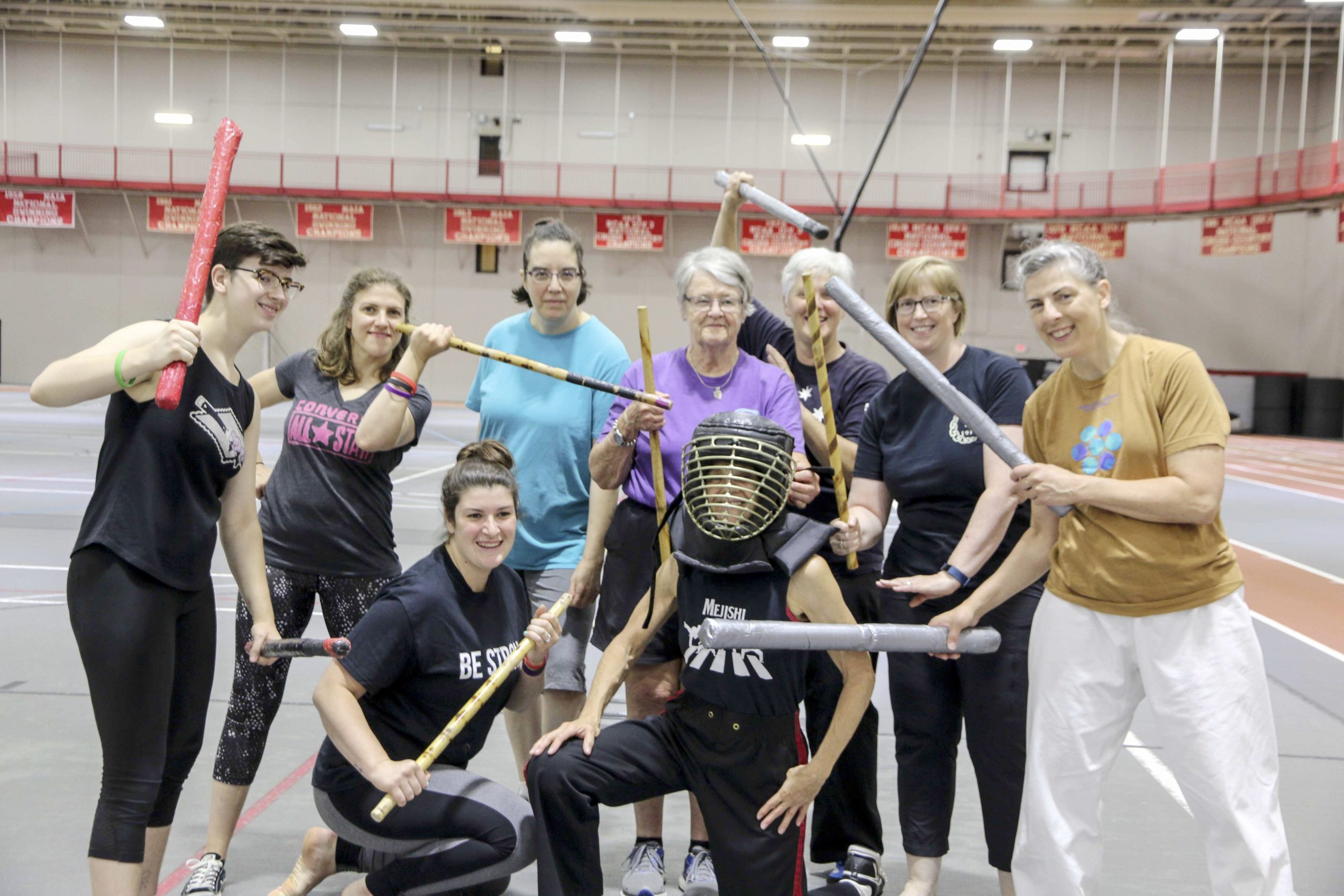 Group of conference attendees posing with weapons
