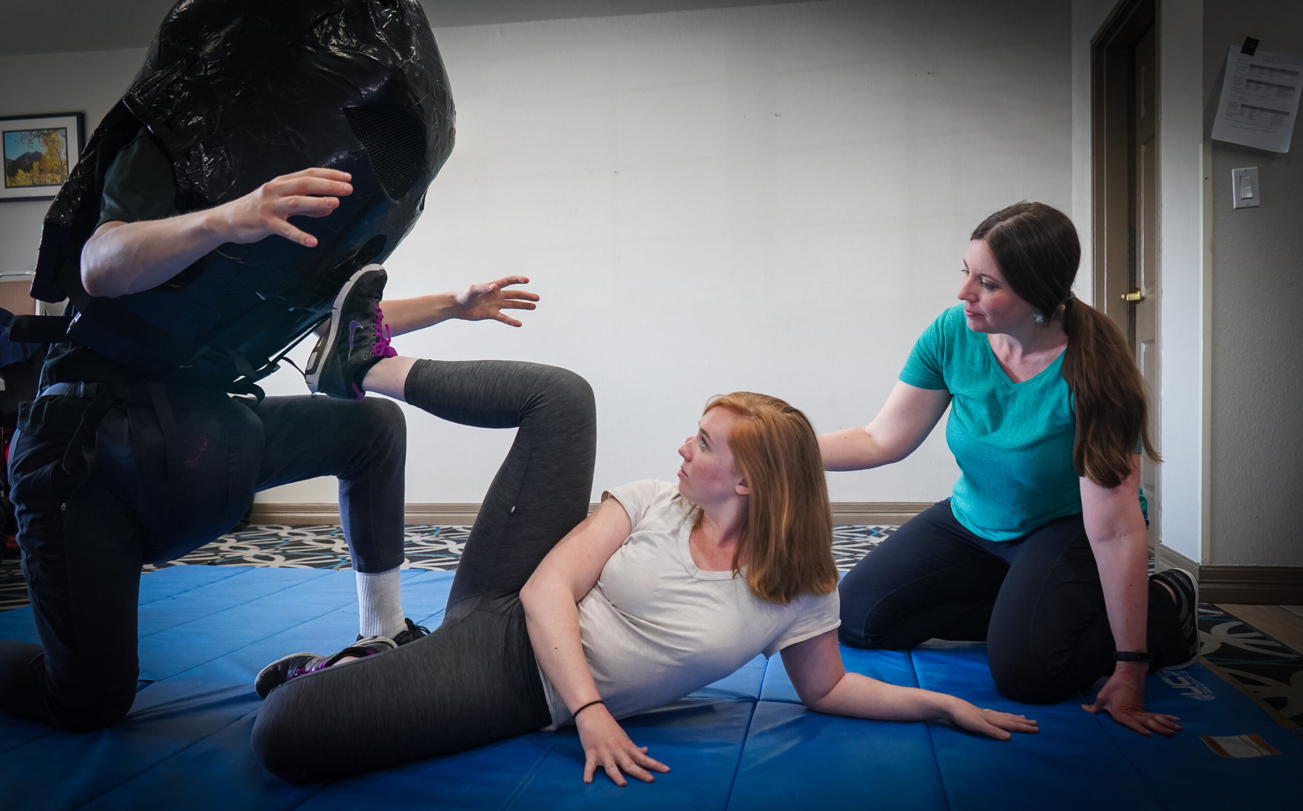 women practicing strikes in an empowerment self-defense class