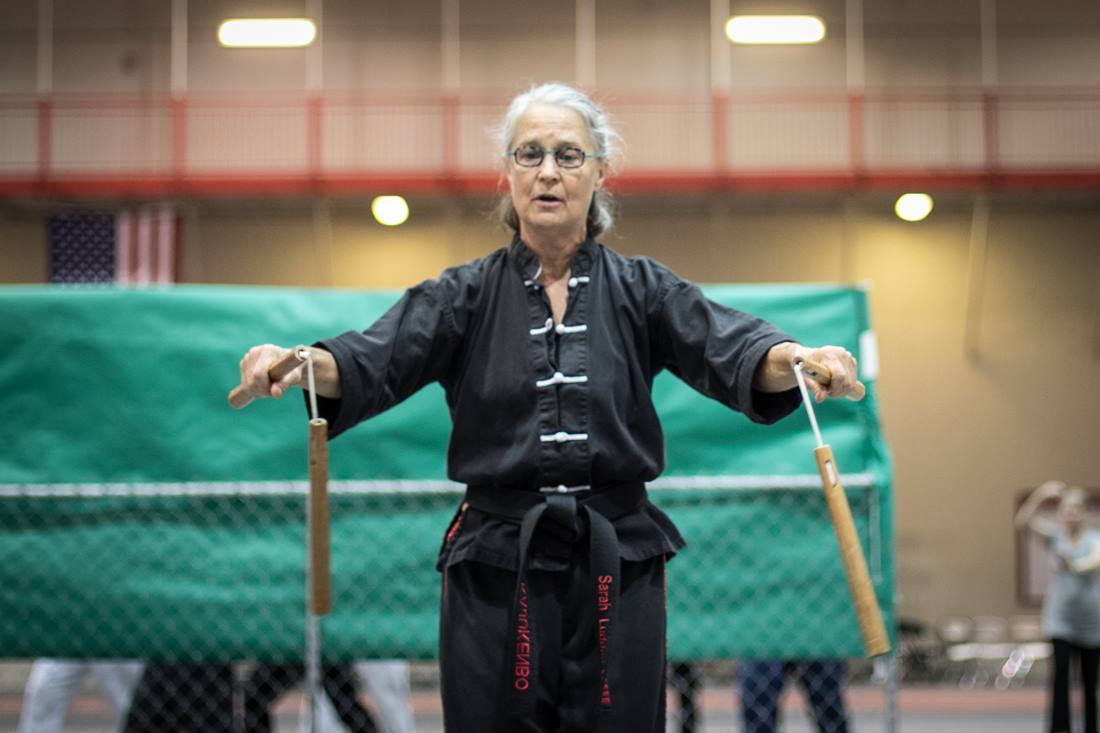 martial artist using nunchaku